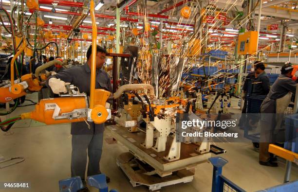 Worker assembles the body of a Mahindra Logan, a new car launched by Renault SA and Mahindra & Mahindra Ltd., in Nashik, India, on Wednesday, April...