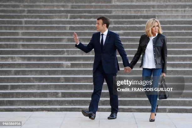 French President Emmanuel Macron arrives with his wife Brigitte Macron to attend an interview with journalists from BFM television and the Mediapart...