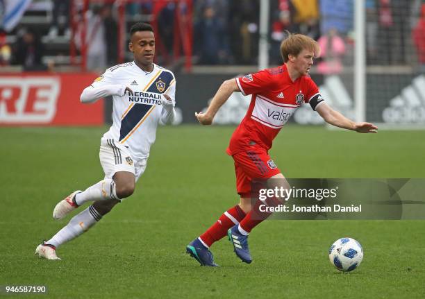 Dax McCarty of the Chicago Fire controls the ball in front of Ola Kamara of the Los Angeles Galaxy at Toyota Park on April 14, 2018 in Bridgeview,...