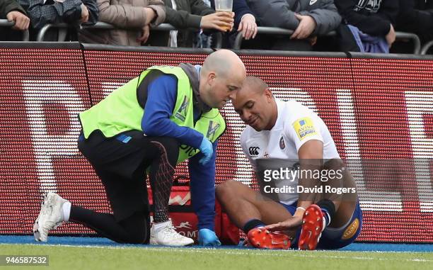 Jonathan Joseph of Bath receives attention to a foot injury, before being replaced, during the Aviva Premiership match between Saracens and Bath...