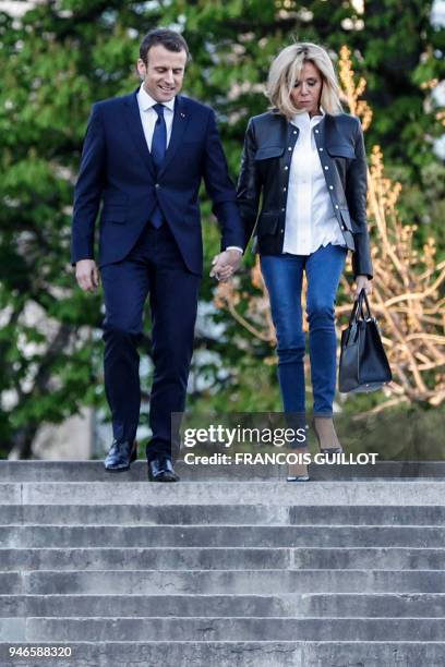 French President Emmanuel Macron arrives with his wife Brigitte Macron to attend an interview with journalists from BFM television and the Mediapart...