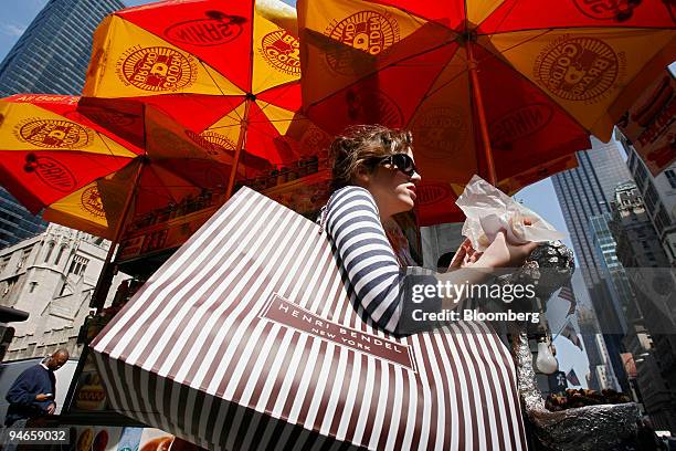 Marisa Marone gets a snack from a street vendor as she shops on 5th Avenue in New York, Tuesday, April 3, 2007. Warmer weather spurred a 4.9 percent...