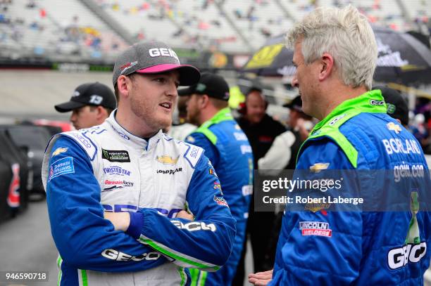 Ty Dillon, driver of the GEICO Chevrolet, talks with a crew member during a red flag rain delay during the Monster Energy NASCAR Cup Series Food City...