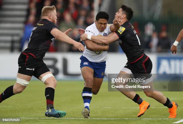 Ben Tapuai of Bath is tackled by Jackson Wray and Sean Maitland during the Aviva Premiership match between Saracens and Bath Rugby at Allianz Park on...