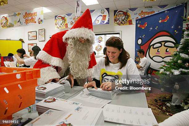 Postal workers reply to letters addressed to Santa Claus at the La Poste office in Libourne, in the Bordeaux region of France, on Wednesday, Nov. 28,...