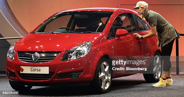 Woman looks at the General Motors Opel Corsa, on display during its launch at the British International motor show in London, U.K., on Tuesday, July...
