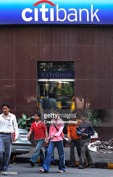 People walk past a branch of Citibank in Mumbai, India, on Thursday, Nov. 29, 2007. India's economy grew last quarter at the slowest pace since 2006,...