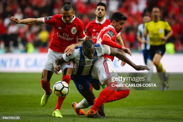 Porto's Malian forward Moussa Marega vies with Benfica's Serbian midfielder Ljubomir Fejsa and Benfica's defender Andre Almeida during the Portuguese...