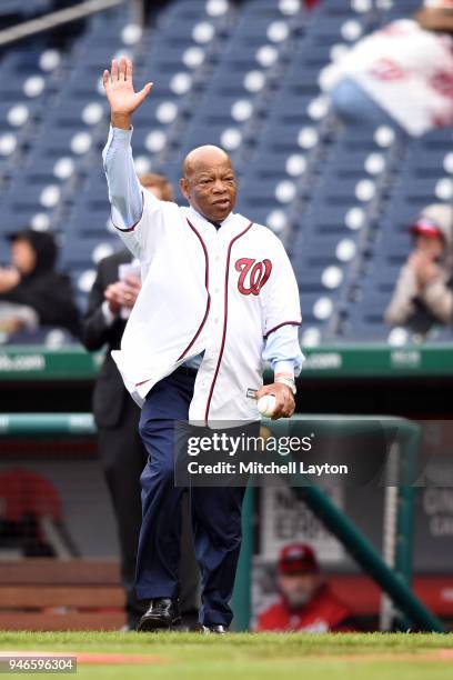 Congressman John Lewis walks out on the field to throw out the first pitch before a baseball game between the Washington Nationals and the Colorado...