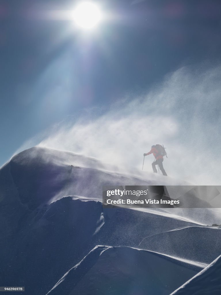 Climber on a snowy slope in a snow storm