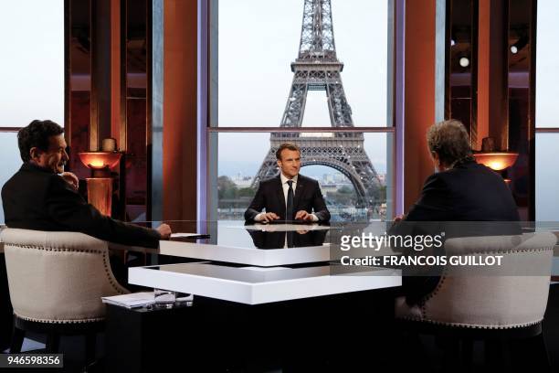 French President Emmanuel Macron poses on the TV set before an interview with RMC-BFM French journalist Jean-Jacques Bourdin and Mediapart...