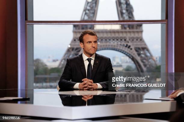 French President Emmanuel Macron poses on the TV set before an interview with RMC-BFM and Mediapart French journalists at the Theatre national de...
