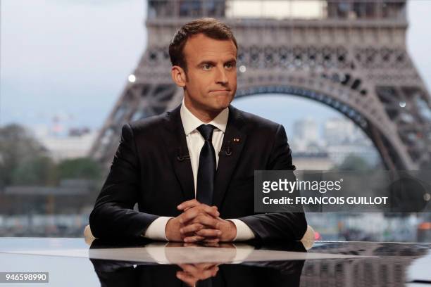 French President Emmanuel Macron poses on the TV set before an interview with RMC-BFM and Mediapart French journalists at the Theatre national de...