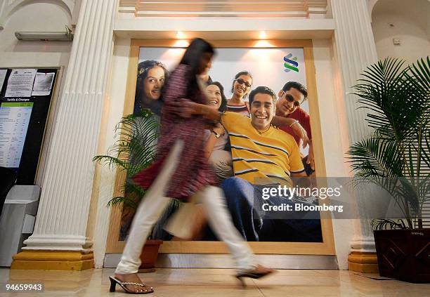 Woman walks past a Standard Chartered Bank advertisement in Mumbai, India, on Thursday, Nov. 29, 2007. India's economy grew last quarter at the...