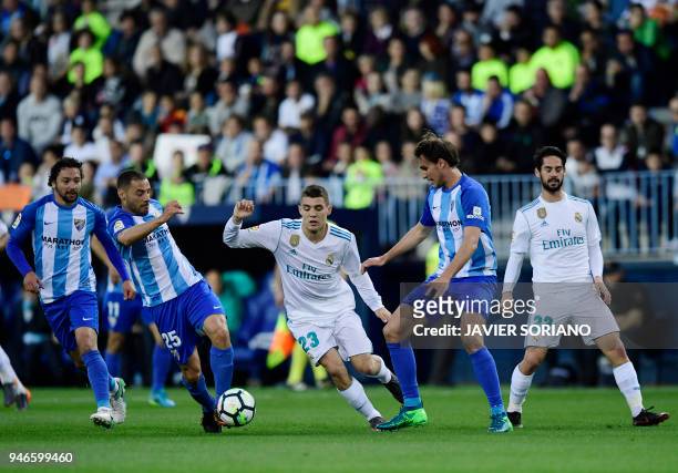 Real Madrid's Croatian midfielder Mateo Kovacic vies with Malaga's Uruguayan defender Federico Ricca during the Spanish league footbal match between...