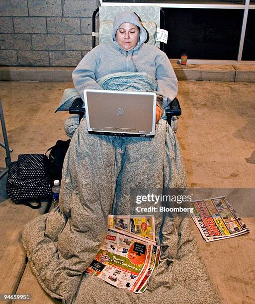 Angela York works on her computer as she settles in for the night outside a Best Buy store in El Cajon, California, late Thursday night, November 23,...