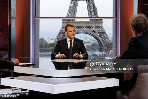 French President Emmanuel Macron poses on the TV set before an interview with RMC-BFM and Mediapart French journalists at the Theatre national de...