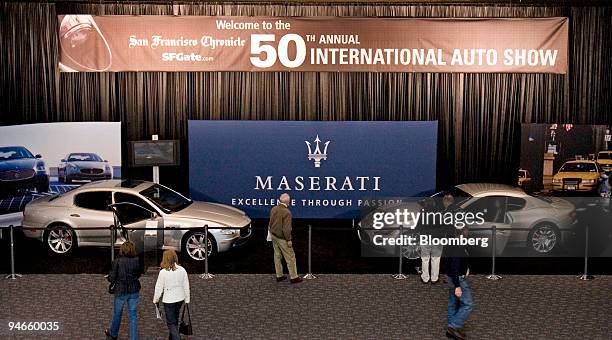 People look at the Maserati Quattroporte, left, and Gran Turismo models at the entrance of 50th Annual International Auto Show in San Francisco,...