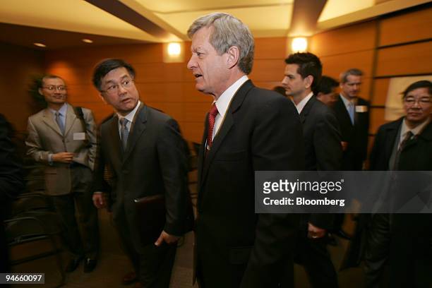 Former Washington Governor Gary Locke, left, talks to Senate Finance Committee Chairman Max Baucus, a Montana Democrat, after delivering the keynote...