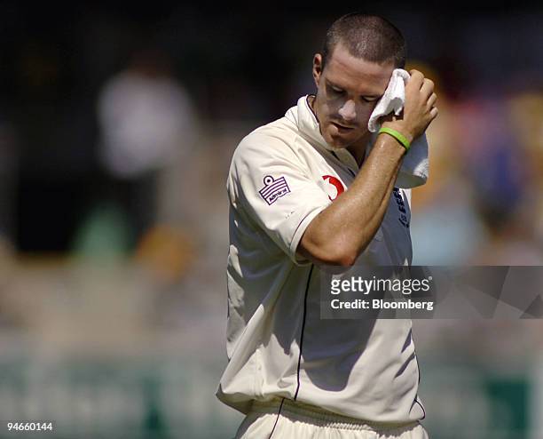 Kevin Pietersen, fielding for England, wipes his face during day 1 of the first Ashes Test at the Gabba Cricket Ground in Brisbane, Australia,...