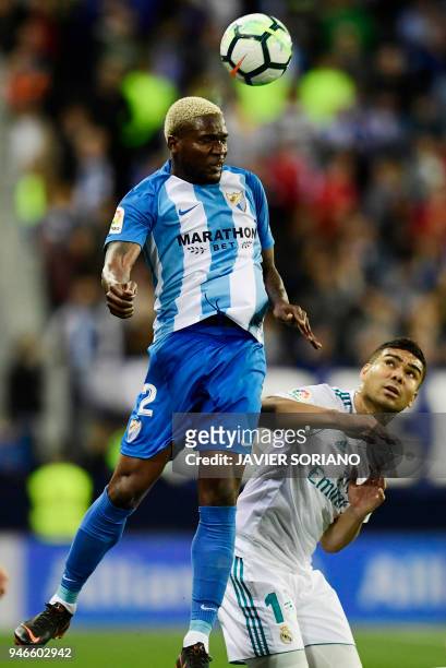 Malaga's Nigerian forward Brown Ideye vies with Real Madrid's Brazilian midfielder Casemiro during the Spanish league footbal match between Malaga CF...