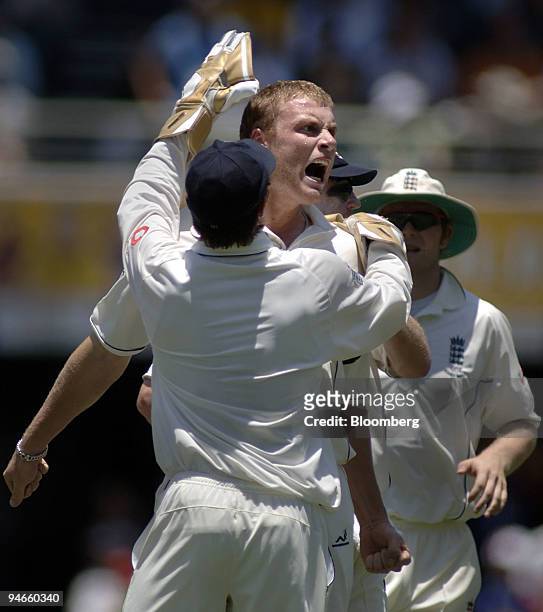 Andrew Flintoff, center, bowling for England, reacts after taking the wicket of Australia's batsman Matthew Hayden, on day 1 the first Ashes Test at...