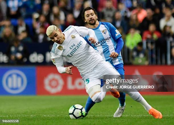 Real Madrid's French defender Theo Hernandez vies with Malaga's Chilean midfielder Manuel Iturra during the Spanish league footbal match between...