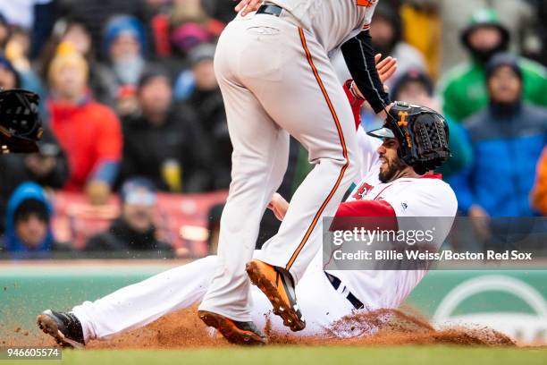 Martinez of the Boston Red Sox slides as he scores on a wild pitch during the sixth inning of a game against the Baltimore Orioles on April 15, 2018...