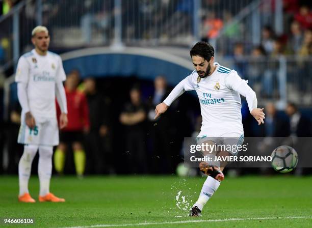 Real Madrid's Spanish midfielder Isco shoots a free kick to score a goal during the Spanish league footbal match between Malaga CF and Real Madrid CF...