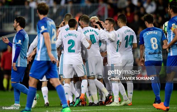 Real Madrid players celebrate their opening goal during the Spanish league footbal match between Malaga CF and Real Madrid CF at La Rosaleda stadium...