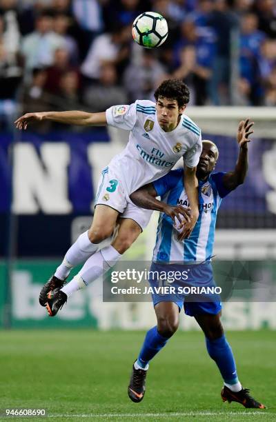 Real Madrid's Spanish defender Jesus Vallejo vies with Malaga's Nigerian forward Brown Ideye during the Spanish league footbal match between Malaga...