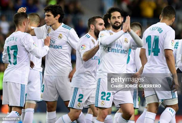Real Madrid's Spanish midfielder Isco celebrates a goal with teammates during the Spanish league footbal match between Malaga CF and Real Madrid CF...