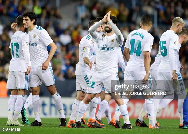 Real Madrid's Spanish midfielder Isco celebrates a goal with teammates during the Spanish league footbal match between Malaga CF and Real Madrid CF...