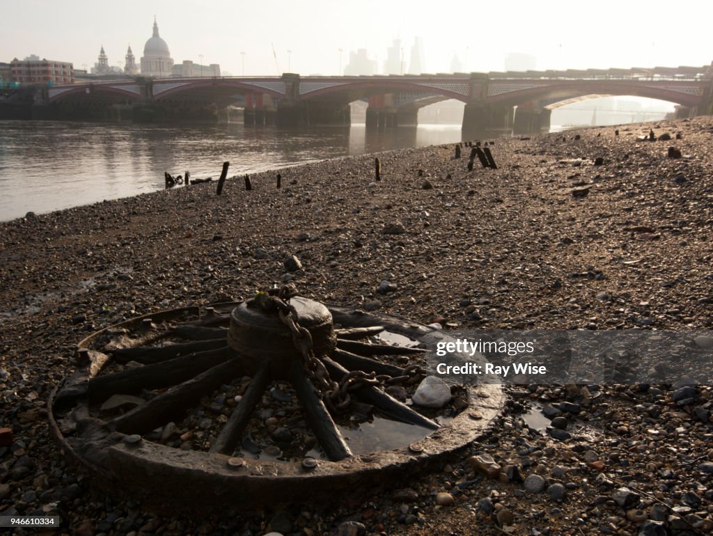 Wheel and chain on beach of River Thames