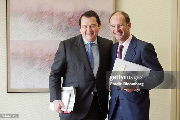 Manuel Gonzalez, BBVA chief financial officer, center, and Jose Barreiro BBVA global business director, left, pose at a news conference in Madrid,...