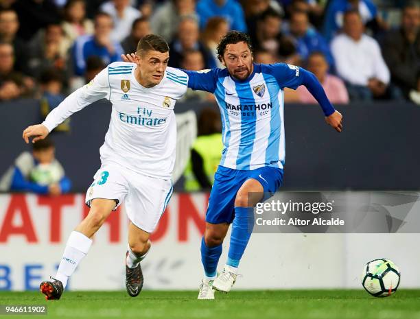 Mateo Kovacic of Real Madrid competes for the ball with Manuel Rolando Iturra of Malaga during the La Liga match between Malaga CF and Real Madrid CF...