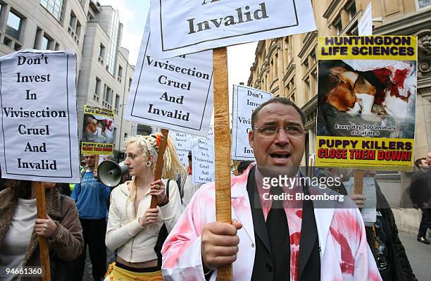Protestor dressed as a doctor in a blood-soaked lab coat shouts slogans during an animal rights protest against Huntingdon Life Sciences in London,...
