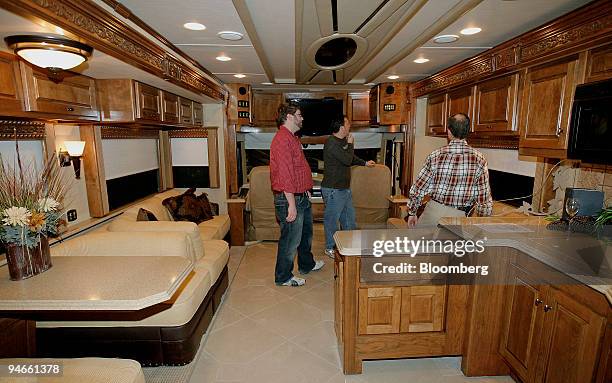 Kyle McKibbin, left, Tony Smith, center, and Mark Vanzandt, right, all from Fleming Indiana, look through a new recreational-vehicle from Monaco...