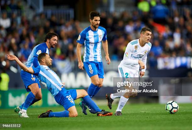 Mateo Kovacic of Real Madrid competes for the ball with Medhi Lacen of Malaga during the La Liga match between Malaga CF and Real Madrid CF at...