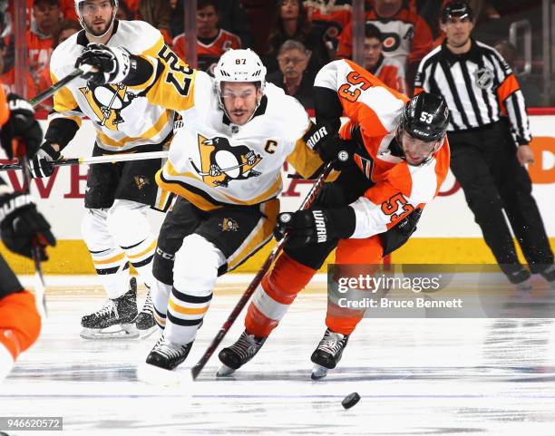 Sidney Crosby of the Pittsburgh Penguins and Shayne Gostisbehere of the Philadelphia Flyers battle for the puck during the first period in Game Three...