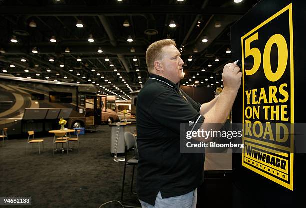 Chad Reece Chad Reece, of Winnebago Industries, works on a display sign at the ...