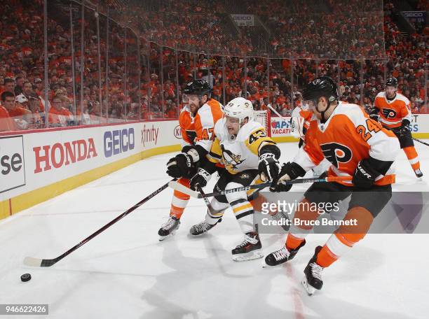 Andrew MacDonald and Matt Read of the Philadelphia Flyers defend against Conor Sheary of the Pittsburgh Penguins during the first period in Game...
