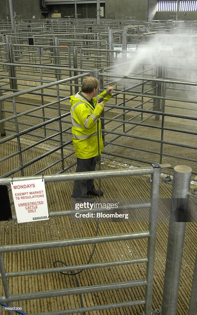 Malcolm Webster cleans empty animal pens at Bakewell market