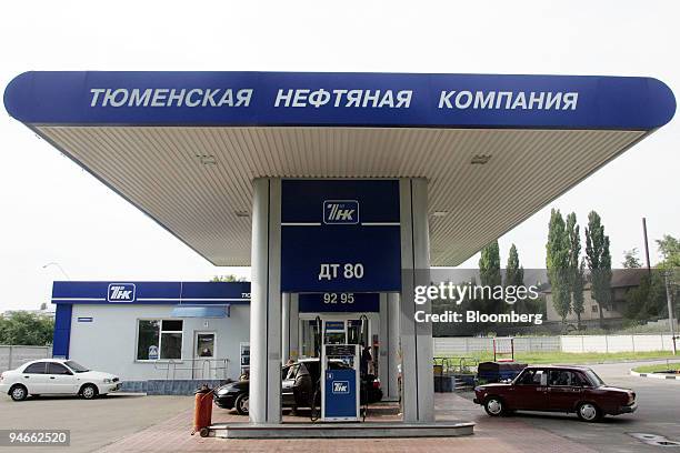 Cars are seen at a TNK-BP gas station near Donetsk, Ukraine, on Friday, July 14, 2006. Russian billionaires who own the TNK-BP oil venture with BP...