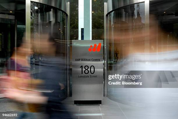 Pedestrians walk past the headquarters of BHP Billiton Ltd. In Melbourne, Australia, on Monday, Nov. 26, 2007. BHP Billiton Ltd., the world's largest...