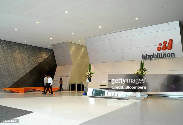 Employees walk through the reception area of BHP Billiton Ltd.'s headquarters in Melbourne, Australia, on Monday, Nov. 26, 2007. BHP Billiton Ltd.,...