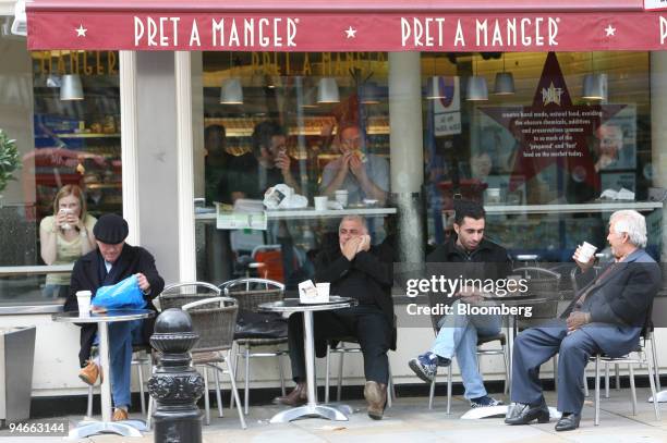 Customers sit outside a Pret A Manger sandwich shop, in London, U.K., Wednesday, April 26, 2006.