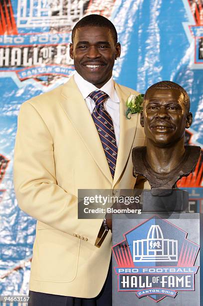 Michael Irvin, former football player with the Dallas Cowboys, poses with a bust in his image after his induction into the Pro Football Hall of Fame...