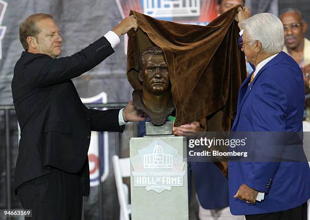 Bob Hickerson, left, son of Gene Hickerson, former player of the Cleveland Browns, unveils his father's bust with presenter Bobby Franklin during...