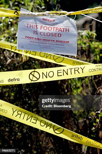 Foot-and-mouth sign closes access to a public footpath close to the contaminated farm at Wanborough, Surrey, U.K., on Saturday, Aug. 4, 2007. The...